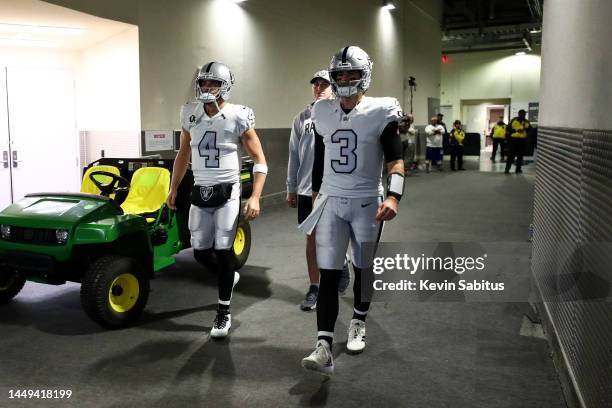 Derek Carr and Jarrett Stidham of the Las Vegas Raiders walk through the tunnel prior to an NFL football game against the Los Angeles Rams at SoFi...