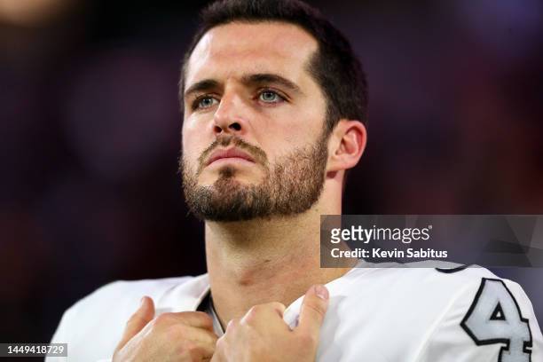 Derek Carr of the Las Vegas Raiders stands on the sidelines during the national anthem prior to an NFL football game against the Los Angeles Rams at...