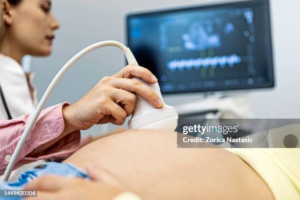 doctor with a pregnant woman - gynecological examination stock pictures, royalty-free photos & images