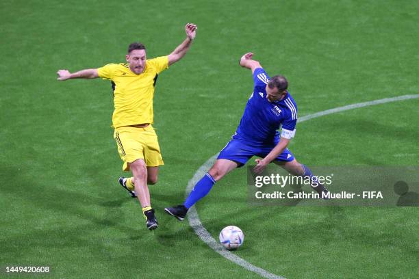 Andrei Shevchenko of European Dragons battles for possession with Francesco Totti of European Wolves during the FIFA Legends Cup match between...