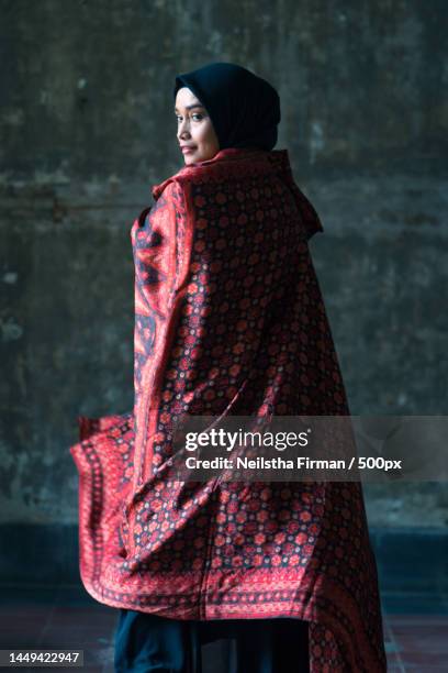 beautiful woman in black hijab wearing batik from jambi,indonesia,jakarta - batik indonesia stock pictures, royalty-free photos & images