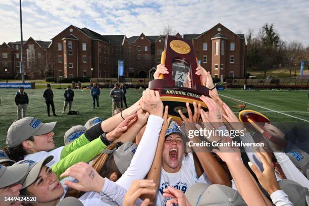 Molly Reich of the Johns Hopkins Blue Jays celebrates with the trophy after defeating the Case Western Reserve Spartans to win the Division III...