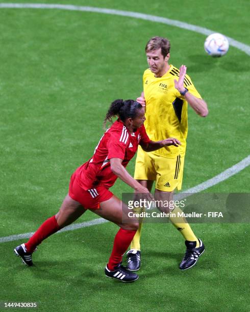 Rosana Augusto of South American Panthers battles for possession with Massimo Ambrosini of European Wolves during the FIFA Legends Cup match between...