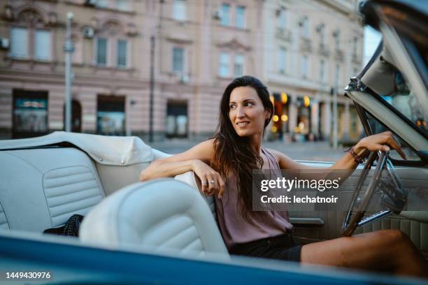 young woman going out for a drive - chevrolet cabriolet stock pictures, royalty-free photos & images