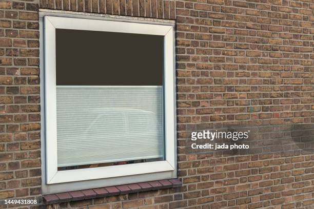 white plastic window frame placed in a wall of an apartment building - brick facade stock pictures, royalty-free photos & images