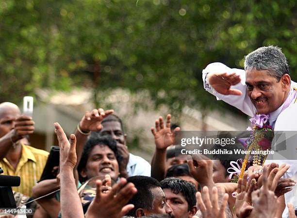 Sri Lankan former army chief Sarath Fonseka waves to his supporters after he was released from jail on May 21, 2012 in Colombo, Sri Lanka. Sri...