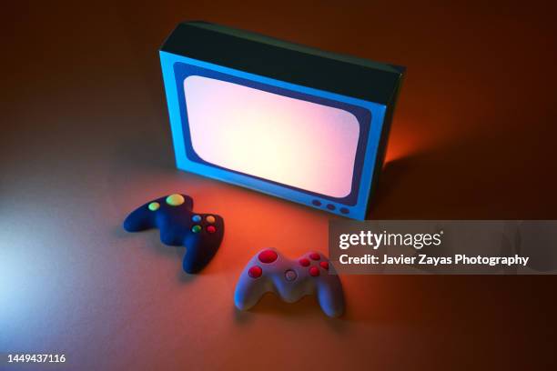 game controllers in front of a vintage style television - retro television set stock pictures, royalty-free photos & images