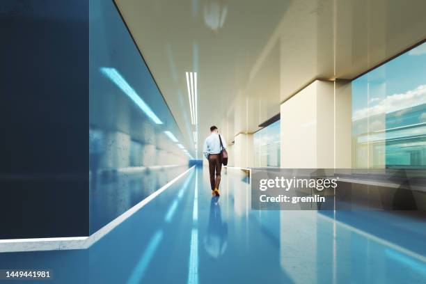 man walking in modern business office corridor - office minimalist stock pictures, royalty-free photos & images