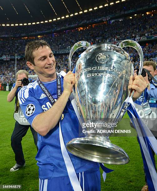 Chelsea's British midfielder Frank Lampard holds the trophy after the UEFA Champions League final football match between FC Bayern Muenchen and...