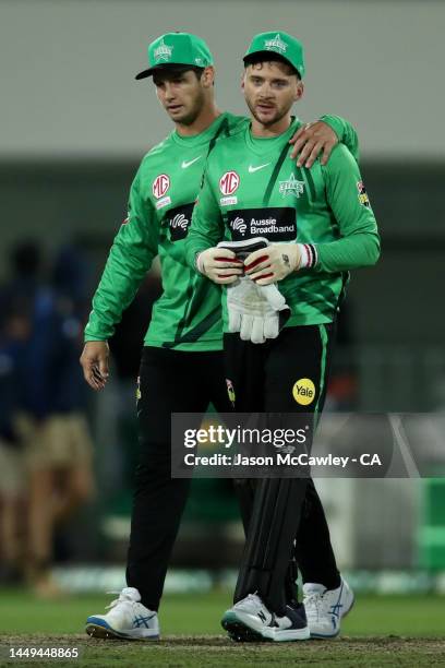 Hilton Cartwright consoles Joe Clarke of the Stars after the Men's Big Bash League match between the Sydney Thunder and the Melbourne Stars at Manuka...