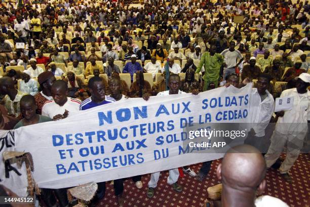 Some of thousands of Malians protest on May 21, 2012 in Bamako a transition deal giving coup leader Amadou Sanogo the status of a former head of...