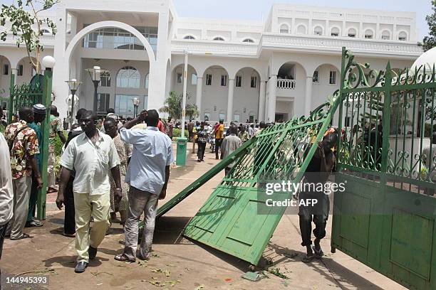 Some of thousands of Malians protest on May 21, 2012 in Bamako after breaking the gates of the presidential palace against a transition deal giving...