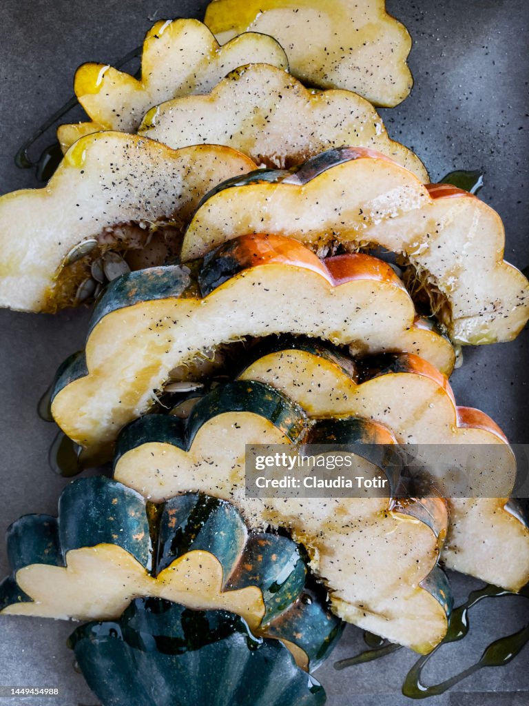 Slices of acorn squash on parchment paper