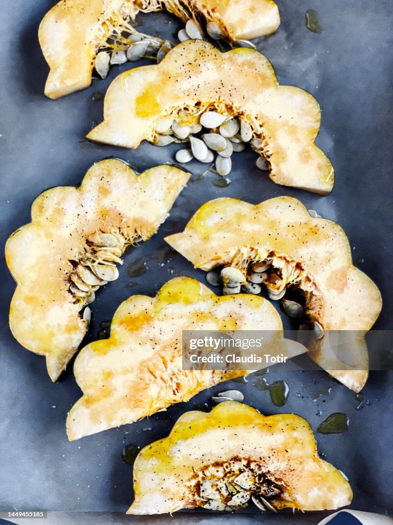 Slices of acorn squash on parchment paper