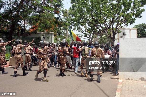 Riot police try to block some of thousands of Malians trying to enter the presidential compound on May 21, 2012 in Bamako during a protest against a...