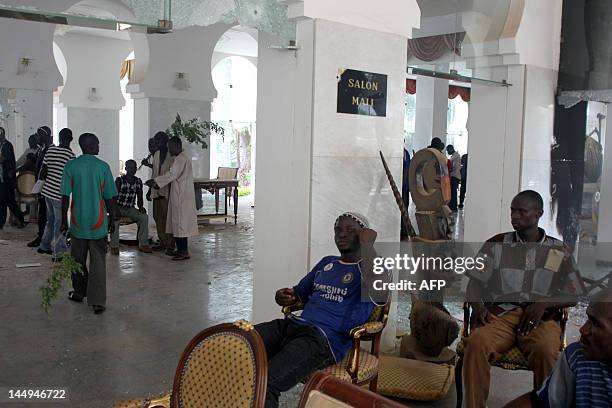 Some of thousands of Malians sit on May 21, 2012 inside the presidential compound in Bamako during a protest against a transition deal giving coup...