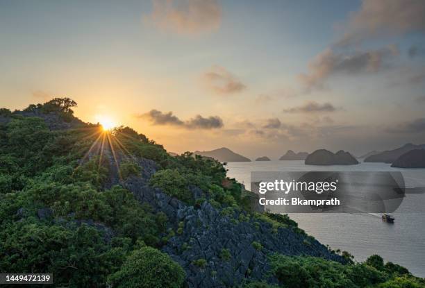 vibrant sunset over the tropical paradise of cat ba island, vietnam in lan ha & ha long bay in southeast asia - vietnam jungle stock pictures, royalty-free photos & images