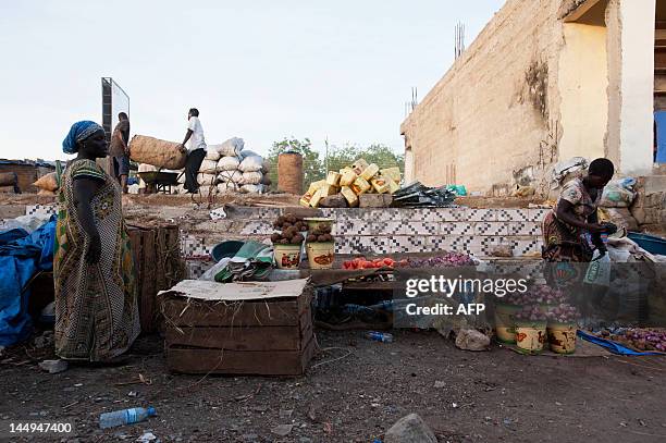 Street vendors take care of their stalls as they wait for customers at the Konyo Konyo market, in Juba, South Sudan on May 18, 2012. Since the...