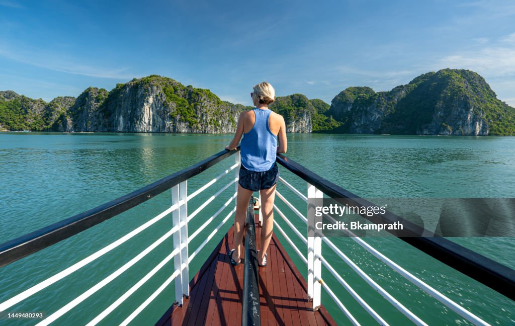 Blonde Woman Enjoying The Breathtaking Lan Ha & Ha Long Bay Accessed via the Tropical Paradise of Cat Ba Island, Vietnam in Southeast Asia