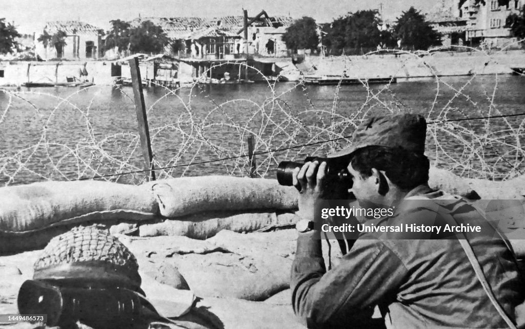 An Israeli soldier looks through his binoculars across the Suez Canal during the 1970 ceasefire agreement between Israel and Egypt