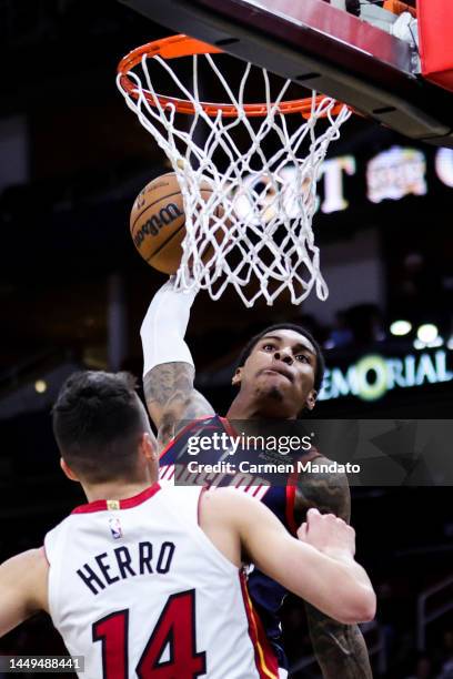 Kevin Porter Jr. #3 of the Houston Rockets dunks the ball over Tyler Herro of the Miami Heat during the first half at Toyota Center on December 15,...