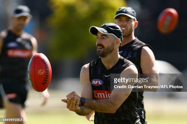 Steele Sidebottom of the Magpies handballs during a Collingwood Magpies AFL training session at AIA Centre on December 16, 2022 in Melbourne,...