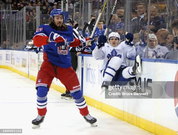 Alexander Kerfoot of the Toronto Maple Leafs is checked by Mika Zibanejad of the New York Rangers during the third period at Madison Square Garden on...