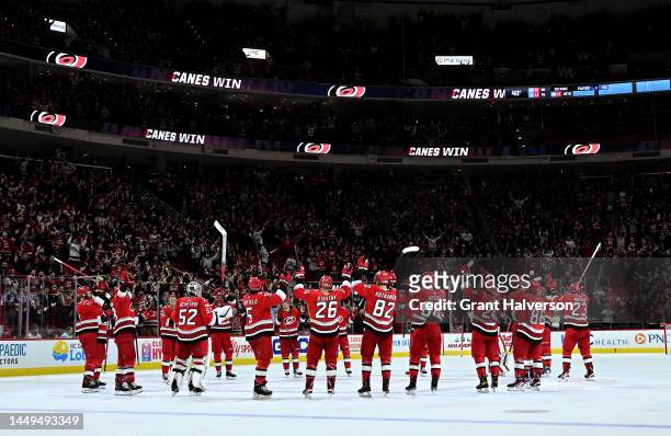 The Carolina Hurricanes celebrate with a Storm Surge after their win against the Seattle Kraken at PNC Arena on December 15, 2022 in Raleigh, North...