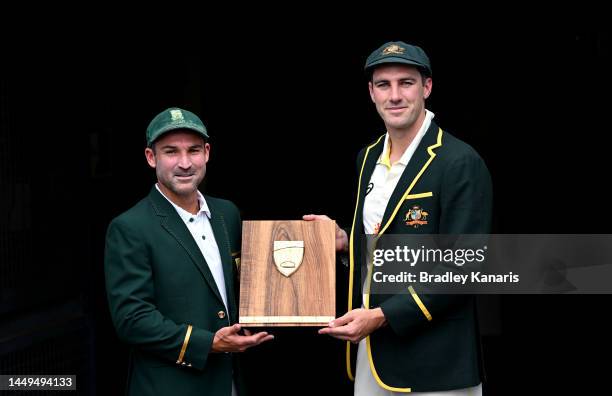 Captains Pat Cummins of Australia and Dean Elgar of South Africa poses for a photo during an Australian Test squad training session at The Gabba on...