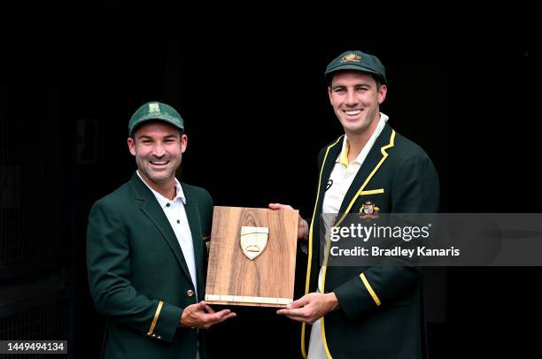 Captains Pat Cummins of Australia and Dean Elgar of South Africa poses for a photo during an Australian Test squad training session at The Gabba on...