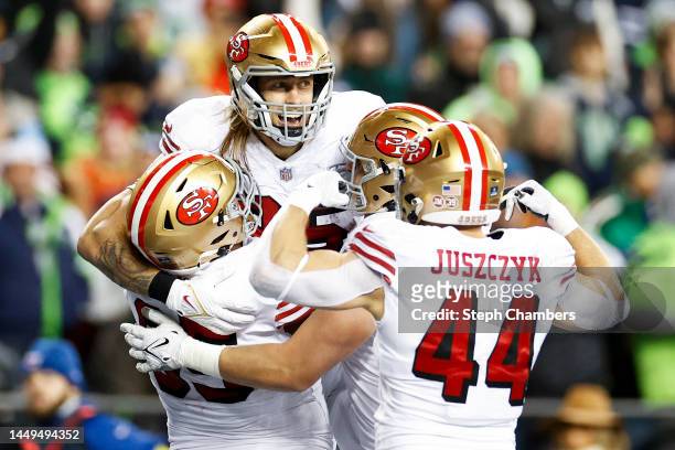 George Kittle of the San Francisco 49ers celebrates with teammates after scoring a touchdown against the Seattle Seahawks during the third quarter of...