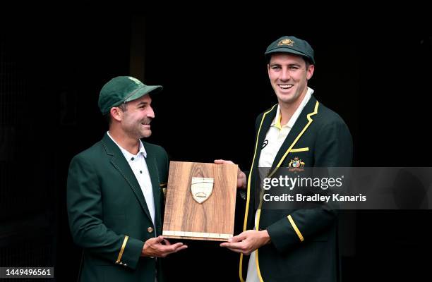 Test Captains Pat Cummins of Australia and Dean Elgar of South Africa share a laugh as they pose for a photo during an Australian Test squad training...