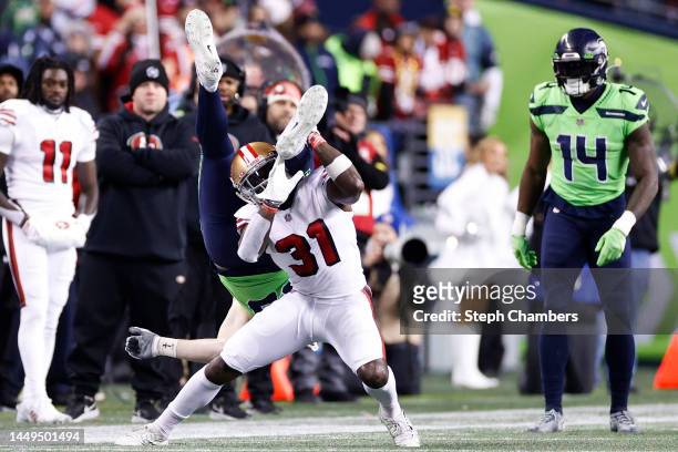 Tashaun Gipson Sr. #31 of the San Francisco 49ers tackles Will Dissly of the Seattle Seahawks during the fourth quarter of the game at Lumen Field on...