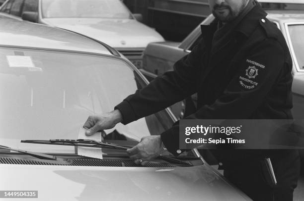 Assignment Meulenhof; parking attendant slips receipt behind windshield wiper, March 31, 1988.
