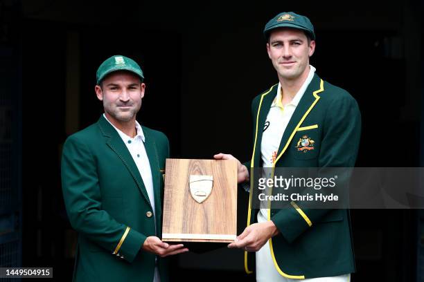 Captains Pat Cummins of Australia and Dean Elgar of South Africa pose at The Gabba on December 16, 2022 in Brisbane, Australia.