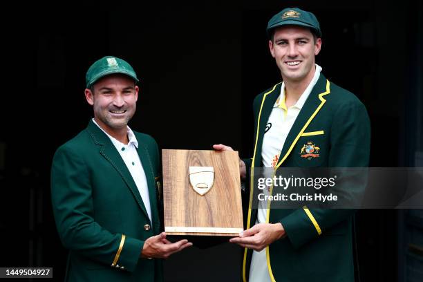 Captains Pat Cummins of Australia and Dean Elgar of South Africa pose at The Gabba on December 16, 2022 in Brisbane, Australia.