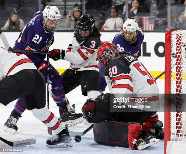 Kristen Campbell of Team Canada makes a save against Hilary Knight and Amanda Kessel of Team United States as Jocelyne Larocque of Team Canada...