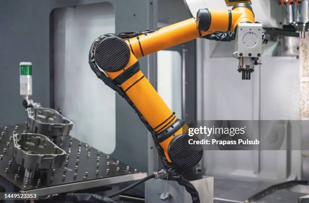 robot arm 's going to pick parts to cnc machine in the manufacturing factory - car assembly line control stock pictures, royalty-free photos & images