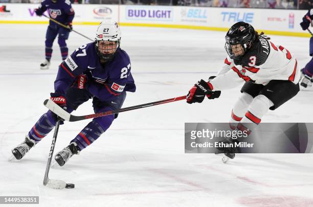 Taylor Heise of Team United States skates with the puck against Jocelyne Larocque of Team Canada in the third period of a Rivalry Series game at The...
