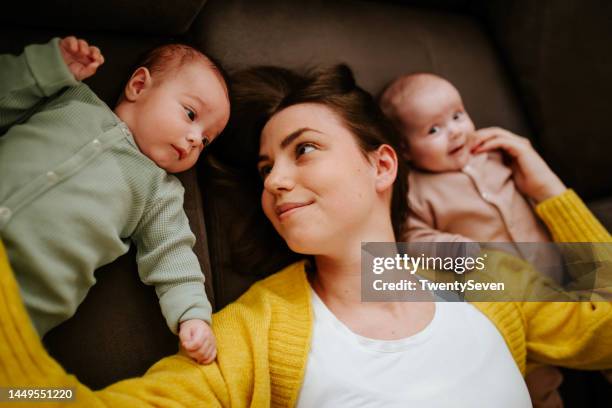 mother enjoying with her twin babies - maternity leave stock pictures, royalty-free photos & images