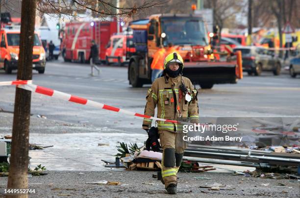 Emergency workers respond at the scene of a broken giant aquarium, on December 16, 2022 in Berlin, Germany. The aquarium, located in the Radisson...
