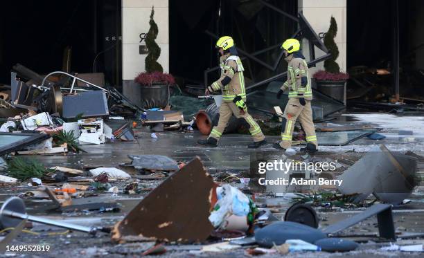 Emergency workers respond at the scene of a broken giant aquarium, on December 16, 2022 in Berlin, Germany. The aquarium, located in the Radisson...