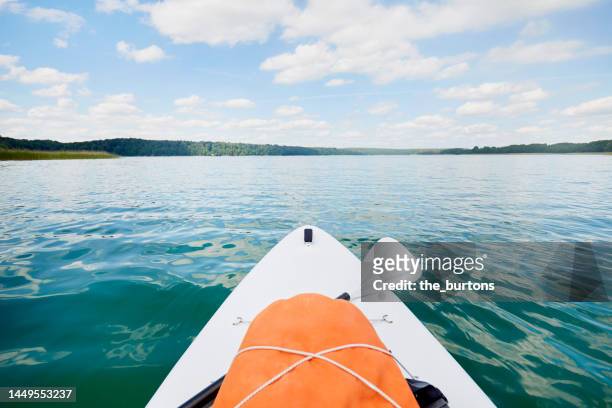 top of a sup surfboard on an idyllic lake in summer, clouds and blue sky are reflected in the smooth water - sea ​​of ​​clouds stock pictures, royalty-free photos & images