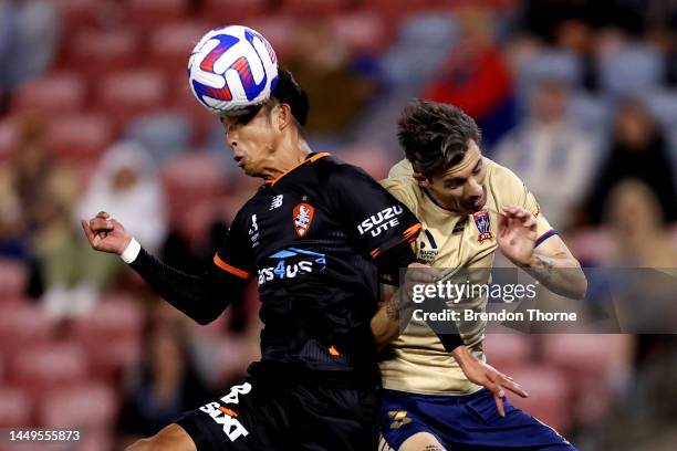 Riku Danzaki of the Roar competes with Jason Hoffman of the Jets during the round eight A-League Men's match between Newcastle Jets and Brisbane Roar...