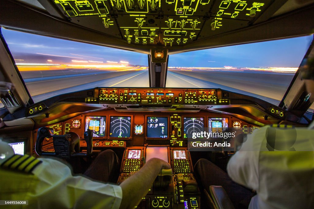 Airliner Cockpit With A Pilot And A Co pilot And Runway Viewed From airliner-cockpit-with-a-pilot-and-a-co-pilot-and-runway-viewed-from
