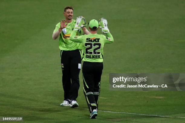 Daniel Sams of the Thunder celebrates after taking the wicket of Thomas Kelly of the Strikers during the Men's Big Bash League match between the...