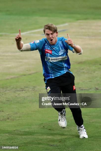 Henry Thornton of the Strikers celebrates after taking the wicket of Jason Sangha of the Thunder during the Men's Big Bash League match between the...