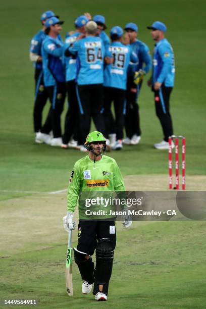 Alex Hales of the Thunder walks off the field after been dismissed by Wes Agar of the Strikers during the Men's Big Bash League match between the...