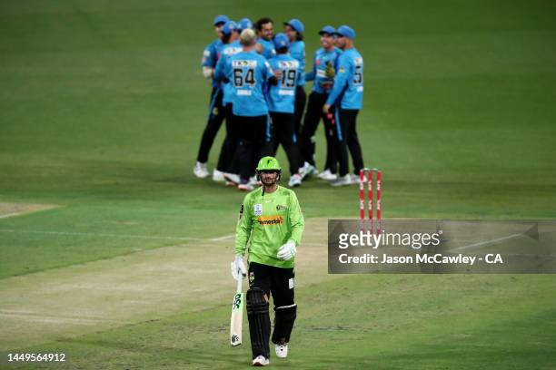 Alex Hales of the Thunder walks off the field after been dismissed by Wes Agar of the Strikers during the Men's Big Bash League match between the...