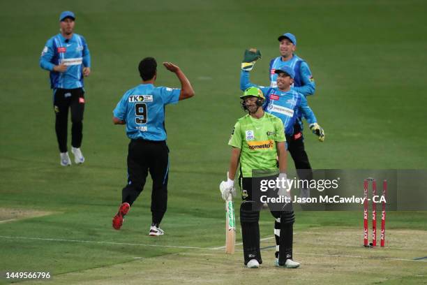 Daniel Sams of the Thunder walks off the field after been dismissed by Wes Agar of the Strikers during the Men's Big Bash League match between the...